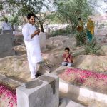 People offering Fateha on graves of their relatives in a local graveyard on the occasion of Eidul Azha
