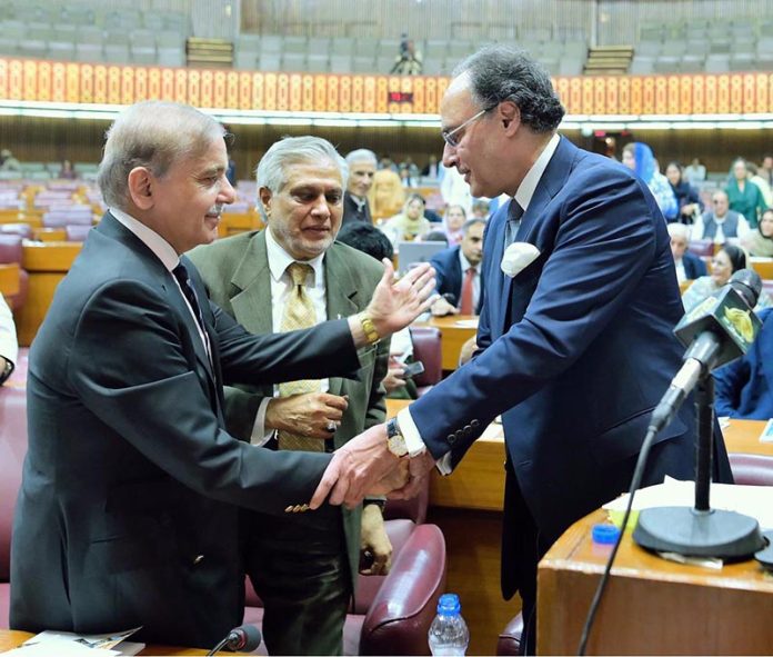 Prime Minister Muhammad Shehbaz Sharif congratulates Federal Minister for Finance and Revenue Muhammad Aurangzeb after his budget speech