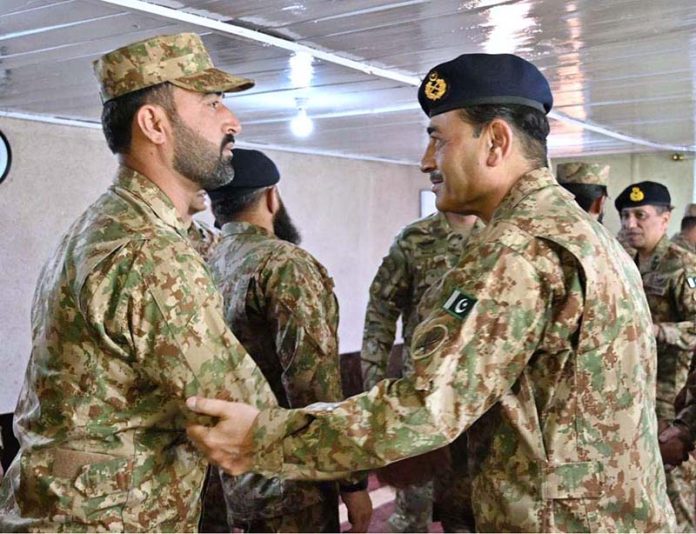 Field Marshal Syed Asim Munir, NI (M), Chief of Army Staff (COAS) interacting with troops while visiting forward positions along the Line of Control (LOC) to celebrate the Eidul Azha with frontline troops
