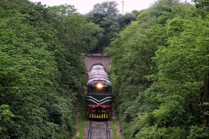 A Pakistan Railways train from Rawalpindi to Lahore, passing through the Korang Tunnel, The tunnel is part of an integrated infrastructure, located adjacent to the Korang Bridge, which spans the Korang River - originating from the Murree Hills constructed by British engineers in 1914, the short 50 meter long tunnel is marked by engineering difficulties, owing to cutting through hard rock, Korang Tunnel is an active segment of the Karachi–Peshawar Railway Line, (ML-1). The Lahore-Rawalpindi section constitutes a crucial part of the extensive network of Pakistan Railways spanning 7,789 kilometers