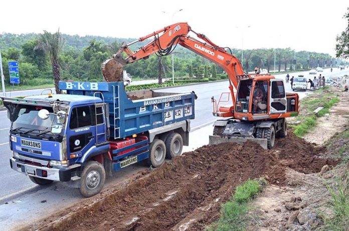 Heavy machinery is being used to excavate land for the construction of a boundary wall along Srinagar Highway, part of efforts to enhance the beauty of Federal Capital