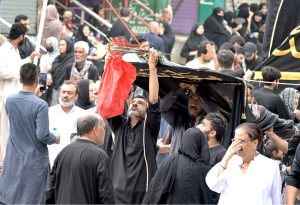 Shia Muslims attend the mourning procession of 10th Muharram ul Harram, to commemorate the death anniversary of Hazrat Imam Hussein, the grandson of prophet Muhammad (PBUH) and his companion, who were martyred in the battle of Karbala, Iraq