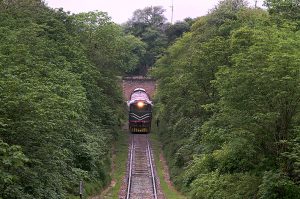 A Pakistan Railways train from Rawalpindi to Lahore, passing through the Korang Tunnel, The tunnel is part of an integrated infrastructure, located adjacent to the Korang Bridge, which spans the Korang River - originating from the Murree Hills constructed by British engineers in 1914, the short 50 meter long tunnel is marked by engineering difficulties, owing to cutting through hard rock, Korang Tunnel is an active segment of the Karachi–Peshawar Railway Line, (ML-1). The Lahore-Rawalpindi section constitutes a crucial part of the extensive network of Pakistan Railways spanning 7,789 kilometers