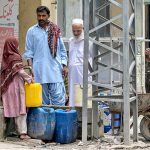 Residents of Tarlai area fetching drinking water from a nearby Naan shop due to insufficient supply of water in the area