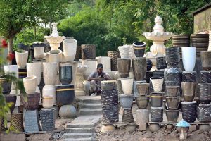 A vendor waits for customers to sell plant pots at Rawal Dam Chowk in the Federal Capital