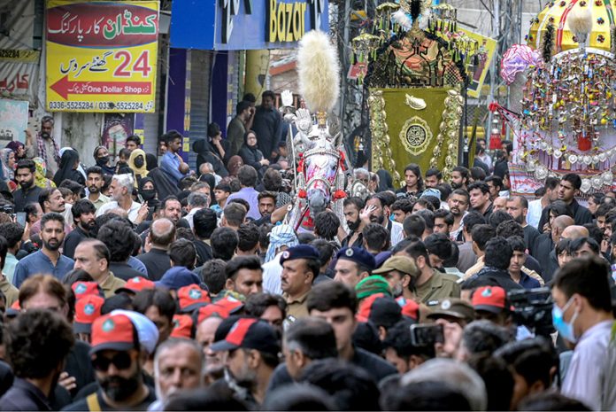 Shia Muslims attend the mourning procession of 10th Muharram ul Harram, to commemorate the death anniversary of Hazrat Imam Hussein, the grandson of prophet Muhammad (PBUH) and his companion, who were martyred in the battle of Karbala, Iraq