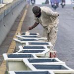 A labourer busy paint the plant pots at 6th Road overhead bridge