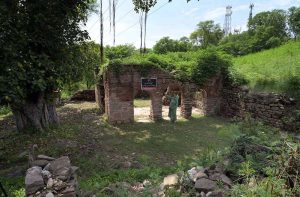 A woman explores the ruins of an ancient mosque situated at the premises of Lotus Lake in the capital. The centuries old abandoned structure was discovered during the development work of the lake in year 2020 in the area, once known as Parian village. The Bunyan tree grown adjacent to the mosque is believed to be some 500 years old.