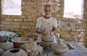 A craftsman preparing clay-made stuff at his work place Kumharpara near Jamshoro road