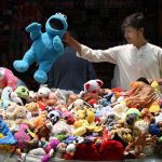 Vendor selling and displaying colorful imported toys on his handcart at Sadar road