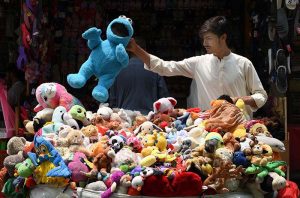 Vendor selling and displaying colorful imported toys on his handcart at Sadar road