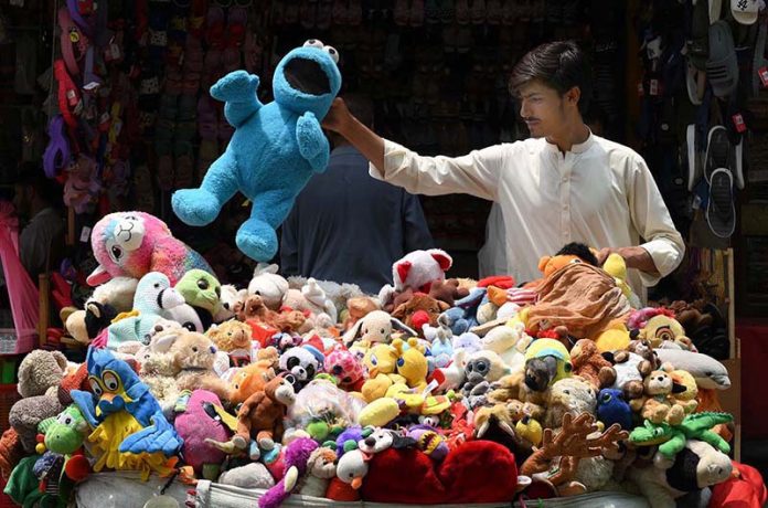 Vendor selling and displaying colorful imported toys on his handcart at Sadar road
