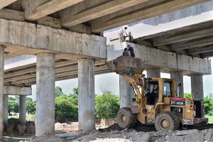 Labourers busy in construction work of flyover at under construction 10th Avenue during development work in Federal Capital