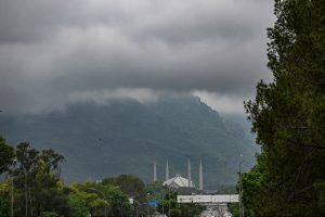 A captivating view of Faisal Masjid as dark monsoon clouds shroud the lush green Margalla Hills, adding to the scenic beauty of the Federal Capital.