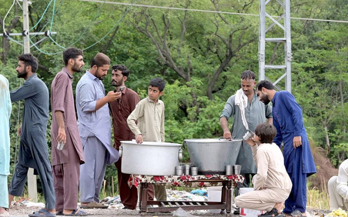 Volunteers serve Sabeel to the people attending the mourning procession of 10th Muharram ul Harram, to commemorate the death anniversary of Hazrat Imam Hussein, the grandson of prophet Muhammad (PBUH) and his companion, who were martyred in the battle of Karbala, Iraq