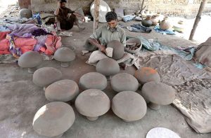 A craftsman preparing clay-made stuff at his work place Kumharpara near Jamshoro road