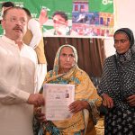 Sindh Senior minister for information Sharjeel Memon giving away ownership rights of the houses constructed under the People's Housing Scheme, flood victims at Rawal house Rahuki