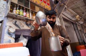 Vendor preparing traditional summer drink 'Gond Kateera sharbat' for customers at Namak Mandi.