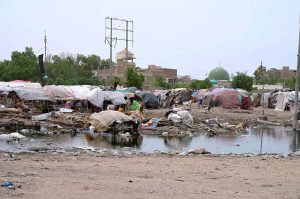 Rainwater accumulates around makeshift huts of gypsies in the Makki Shah area after recent rainfall during monsoon spell.