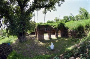 A woman explores the ruins of an ancient mosque situated at the premises of Lotus Lake in the capital. The centuries old abandoned structure was discovered during the development work of the lake in year 2020 in the area, once known as Parian village. The Bunyan tree grown adjacent to the mosque is believed to be some 500 years old.