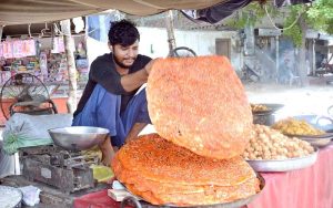 A vendor displaying traditional food itme (Katlama) to attract the customers at his shop.