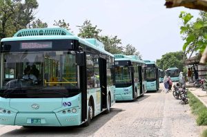 A view of electric buses parked at a bus stop, waiting to pick up passengers in the Federal Capital.