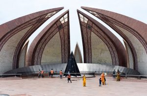 Visitors walk around the Pakistan Monument as sanitation workers clean the premises following rainfall in the Federal Capital yesterday.