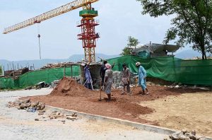 Laborers busy with construction work on the greenbelt near blue area in the Federal Capital.
