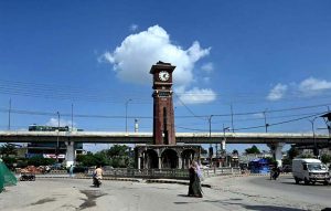 A beautiful view of the clock tower at Rehmanabad Stop with a backdrop of lush blue sky and clouds after rain in the city.