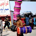 A street hawker carrying hand-made stools shuttling at Pirwadhai area to attract the customers for livelihood