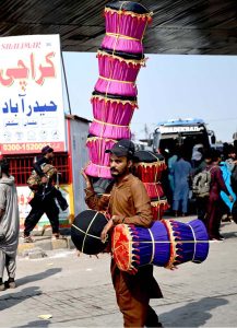 A street hawker carrying hand-made stools shuttling at Pirwadhai area to attract the customers for livelihood