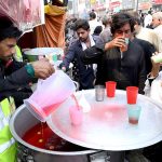 Volunteers serving drinks (Sabeel) to the mourners during procession at Sadar Road on 9th of the Holy Month of Muharram Ul Haram. Muharram Ul Haram is known as the first month of the Islamic calendar and the mourning month in remembrance of the martyrdom (Shahadat) of Hazrat Imam Hussain (AS) the grandson of the Holy Prophet Mohammad (SAWW)