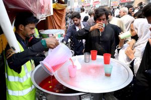 Volunteers serving drinks (Sabeel) to the mourners during procession at Sadar Road on 9th of the Holy Month of Muharram Ul Haram. Muharram Ul Haram is known as the first month of the Islamic calendar and the mourning month in remembrance of the martyrdom (Shahadat) of Hazrat Imam Hussain (AS) the grandson of the Holy Prophet Mohammad (SAWW)