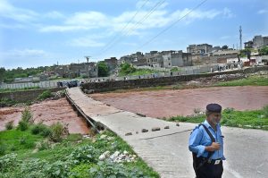 A large crowd has gathered along the Korang Nullah at Sharifabad in the Federal Capital as water levels rose following recent rains. Security personnel are preventing people from crossing the bridge after a young man drowned in the nullah