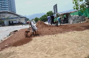 Laborers busy with construction work on the greenbelt near blue area in the Federal Capital.