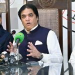 Federal Minister for Railways Hanif Abbasi is talking to the guest of honor at the Press Club