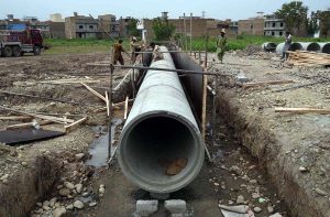 A worker busy welding as construction progresses on the Northern Bypass, connecting Warsak Road to Nasar Bagh Road.