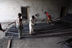 Labourers busy in bending and arranging iron rods at a steel workshop near I-9 area in the Federal Capital