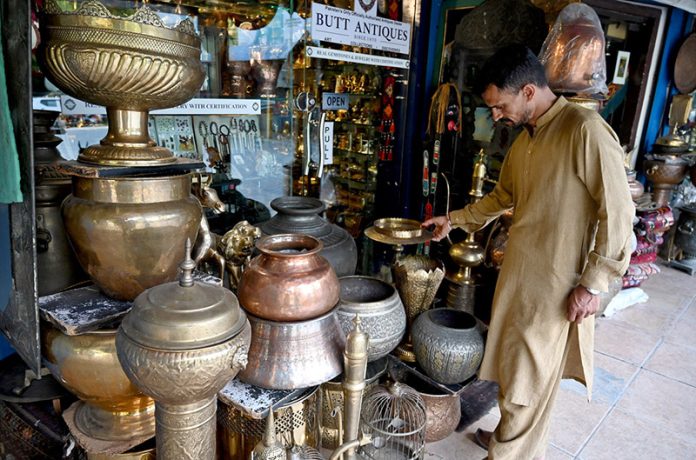 A vendor display antique items to attract customers at Saidpur Village, reflecting its rich cultural heritage in the heart of the Federal Capital