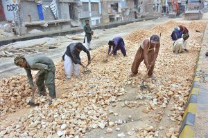 Labourers busy in construction work of new Auto Bahn Road during development work in the city