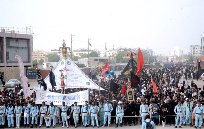 Mourners passing through M.A. Jinnah Road during the 9th Muharram-ul-Haram procession. Muharram ul Harram is the mourning month in remembrance of the martyrdom (Shahadat) of Hazrat Imam Hussain (AS), the grandson of the Holy Prophet Mohammad (SAWW) at the battle of Karbala