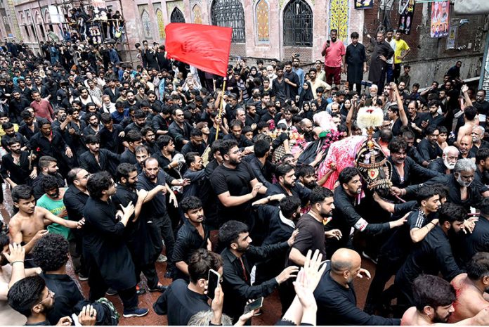 A large number of mourners attending the procession of Aashura on 10th Muharram-ul-Haram. Shia Muslims commemorate the death anniversary of Hazrat Imam Hussein (AS), the grandson of prophet Muhammad (PBUH) and his companion, who were martyred in the battle of Karbala, Iraq