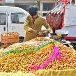 A vendor displaying fresh dates to attract the customers on hand cart at Latifabad
