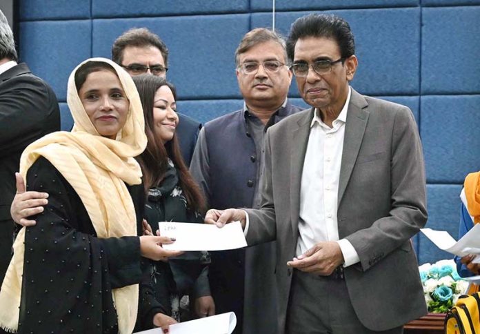 Federal Minister for Education and Professional Training, Dr. Khalid Maqbool Siddiqui, distributes prizes among position holders during the launching ceremony of the Annual Pakistan Non-Formal Education Statistical Report 2023-24 at the Auditorium of Allama Iqbal Open University (AIOU)