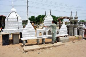 A vendor displaying the dome to attract the customers outside road at Qasimabad.