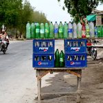 A vendor displaying the petrol in the plastic bottles at Larkana-Ratodero Road