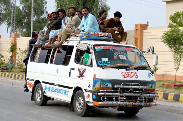 Passengers traveling on the rooftop of a van at Naudero-Ratodero Road may cause any mishap and needs the attention of concerned authorities