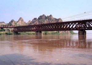 A medium-level flood surges through River Chenab as water levels steadily decline from 104,000 to 76,706 cusecs. Floodwaters continue flowing from Chiniot and Bhawana toward Trimmu Headworks, Jhang.