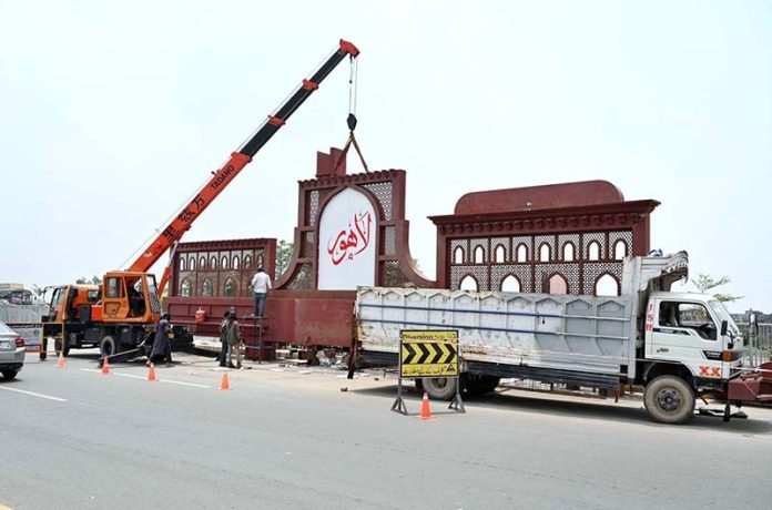 Workers busy in installed the new entrance gate of Lahore near shahdara at River ravi bridge in the Provincial Capital
