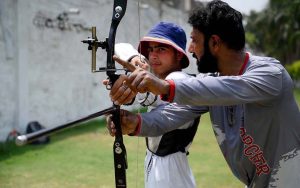 A trainer instructs archery players on how to aim and hit the target during a training session at Qayum Sports Complex.